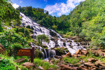 Scenic view of waterfall against sky