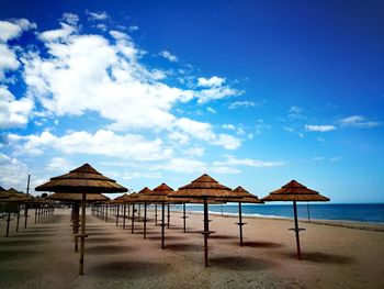 Built structure on beach against blue sky