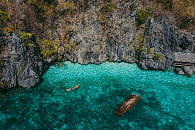 Drone view of man kayaking in sea on sunny day