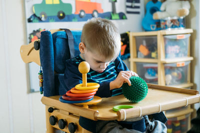 Boy sitting in toy at home