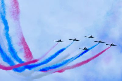 Low angle view of airshow against sky