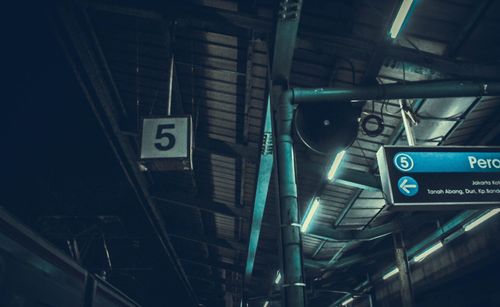 Low angle view of road sign at night