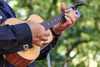 Close-up of man playing guitar outdoors