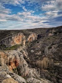 Scenic view of cliff against sky