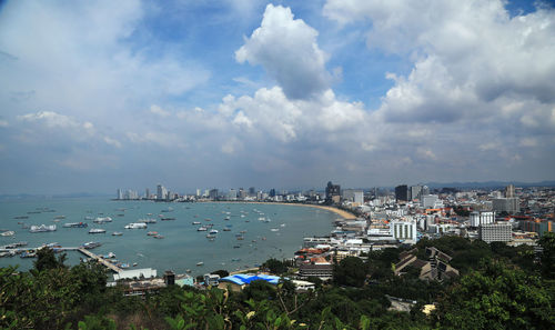 High angle view of bay and buildings against sky