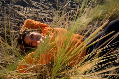 Smiling woman plays in the sand dunes