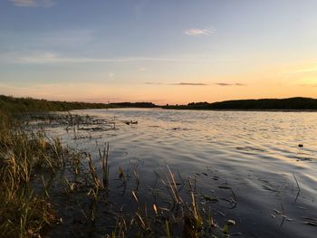 Scenic view of lake against sky during sunset