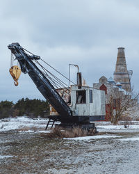 Low angle view of crane against sky