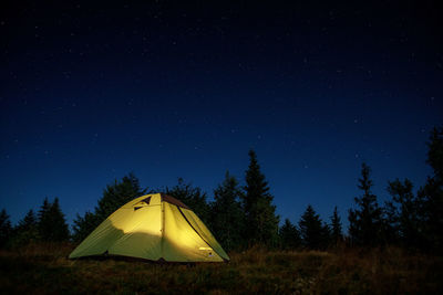 Low angle view of tent against sky at night