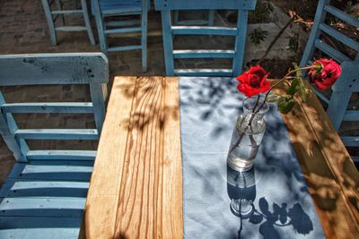 High angle view of roses in vase on table at sidewalk cafe