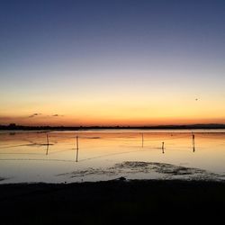 Scenic view of sea against clear sky during sunset