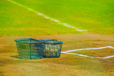 Close-up of shopping cart on field