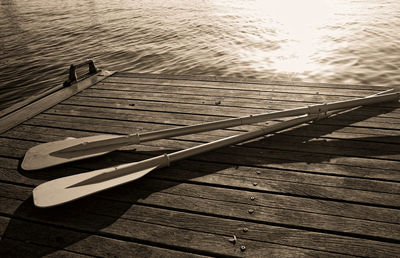 High angle view of oars on pier over lake