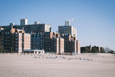 Buildings against clear blue sky