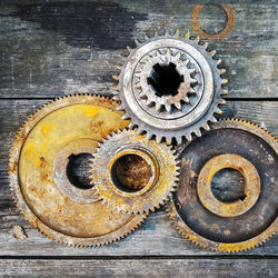 Close-up of rusty gears on wooden table