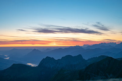 Scenic view of silhouette mountains against sky during sunset