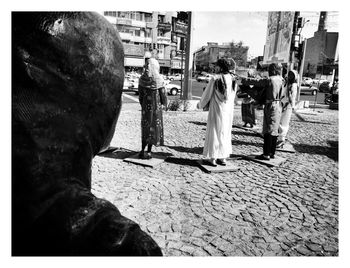 Rear view of people walking on street