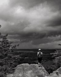 Rear view of man standing on rock
