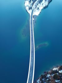 Aerial view of sea against blue sky