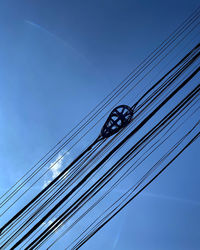Wires against blue sky