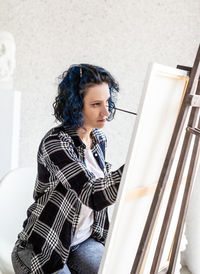 Woman painting at home