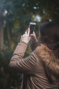 Woman photographing with mobile phone