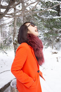 Midsection of woman standing on snow covered land