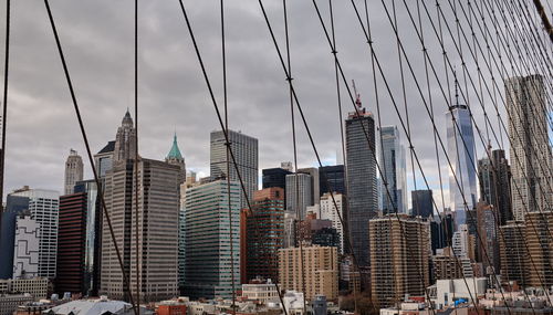 Buildings in city against cloudy sky