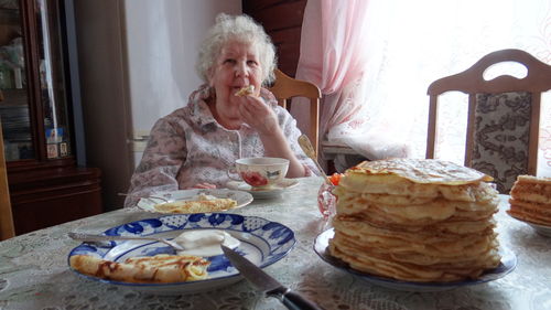 Woman sitting on table at home