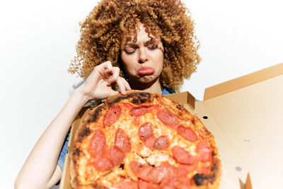 Midsection of woman holding pizza