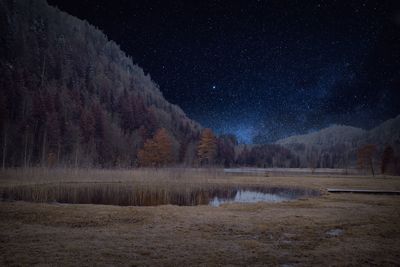 Scenic view of snowcapped mountains against sky at night