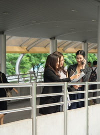 Businesswomen discussing while standing on footbridge