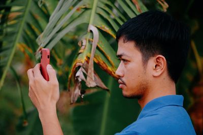 Young man taking selfie outdoors