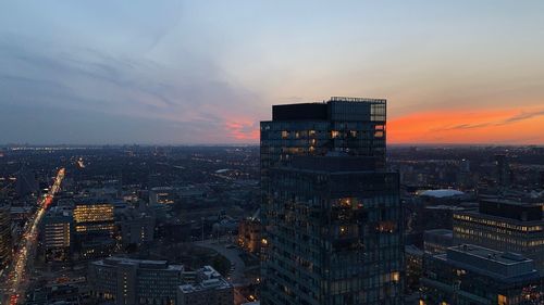 High angle view of illuminated buildings against sky during sunset