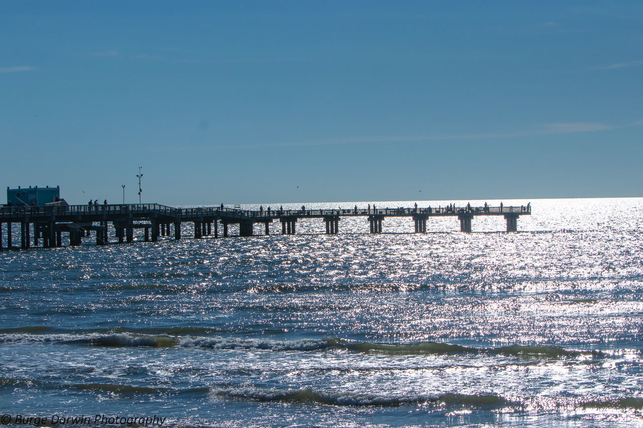 PIER ON SEA AGAINST CLEAR BLUE SKY