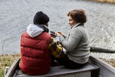 Friends sitting on old boat and talking