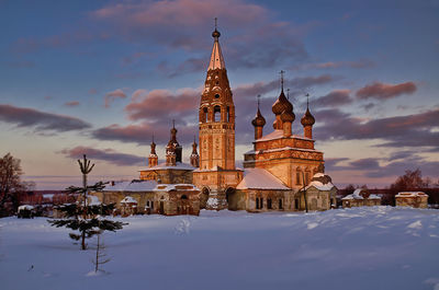 Traditional building against sky during winter