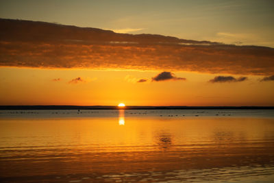 Scenic view of sea against orange sky