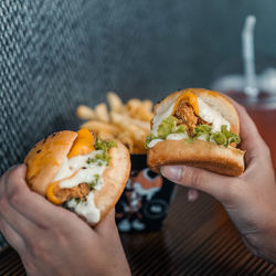 Close-up of hand holding burger