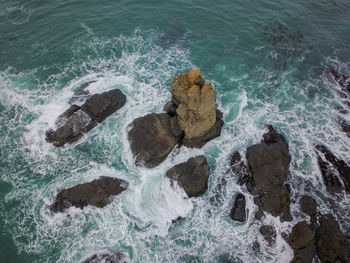 High angle view of rocks in sea