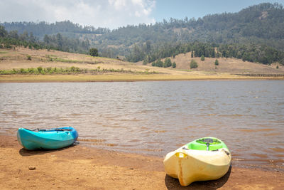 Boat moored on shore at beach