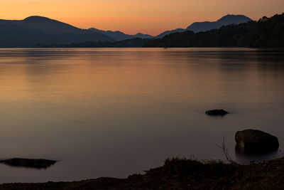 Scenic view of lake against sky during sunset