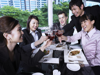 Colleagues with drinks at restaurant during meeting