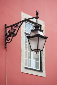 Low angle view of street light on wall