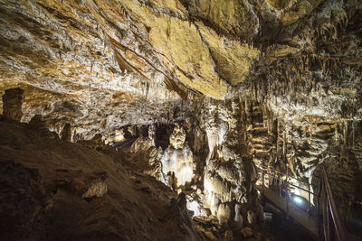 Low angle view of illuminated rock formation in cave