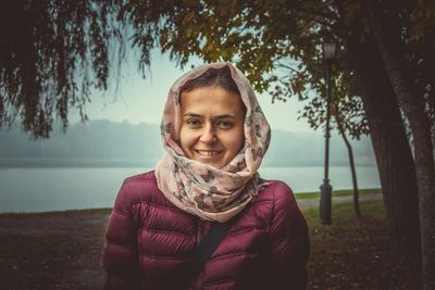 Portrait of smiling young woman at beach