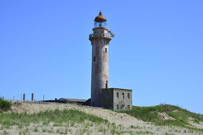 Low angle view of lighthouse against clear blue sky