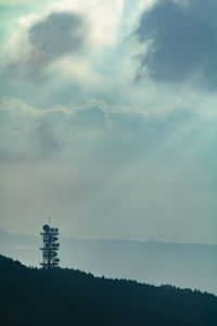 Low angle view of silhouette building against sky