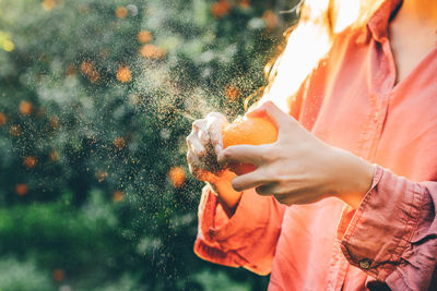 Midsection of woman holding water