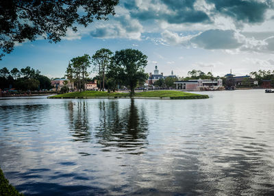 Scenic view of lake against sky in city